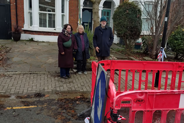 Cllrs Giles and Thompson visit the site of the leak with a resident 